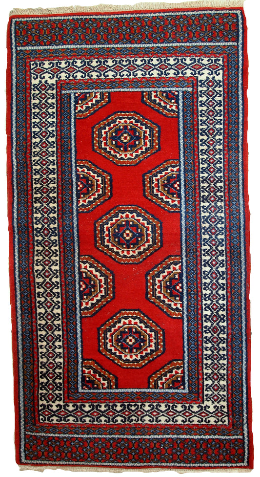 Handmade vintage Indo-Mahal rug featuring a deep red, blue, and white color palette.

