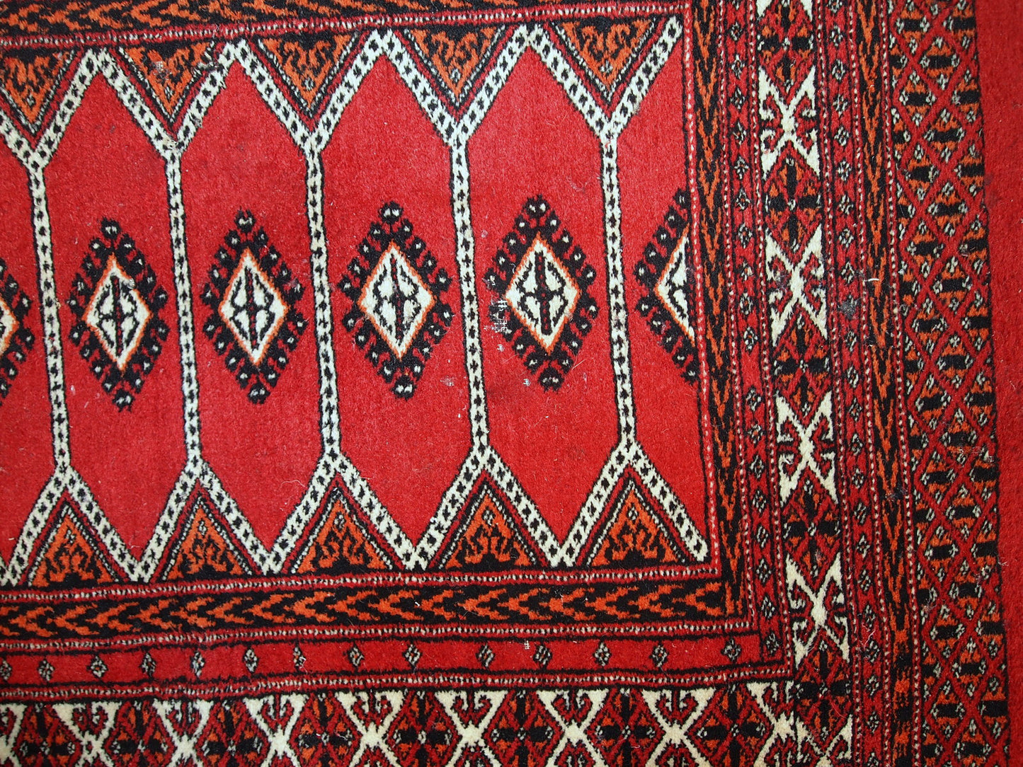 Detailed image of the distressed condition of the handmade Pakistani Lahore rug.

