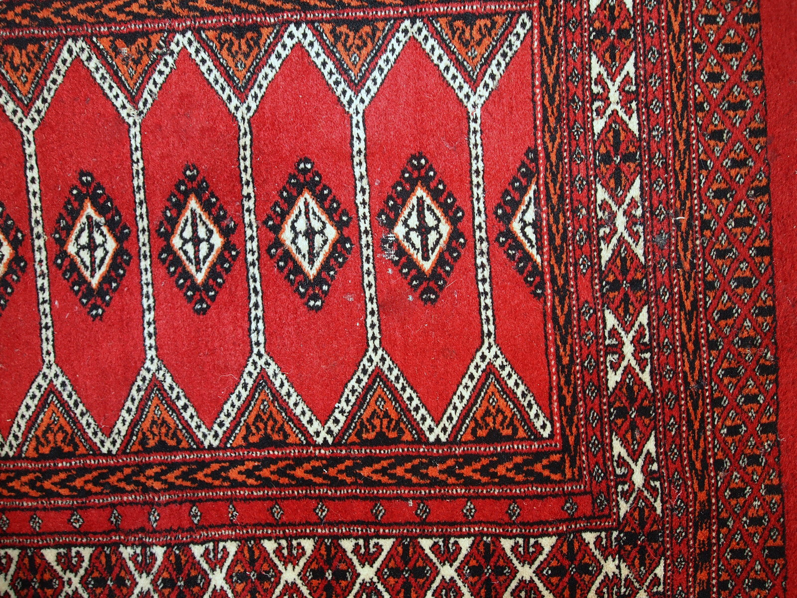 Detailed image of the distressed condition of the handmade Pakistani Lahore rug.

