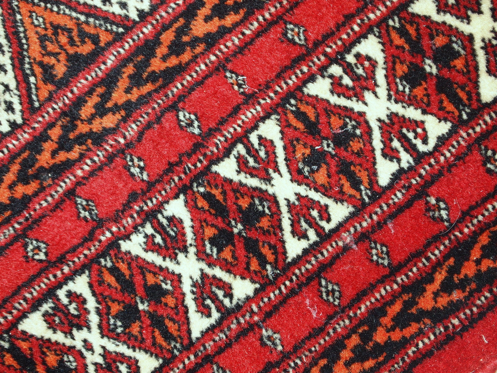 Close-up shot of the distressed wool texture on the 1960s Lahore rug.

