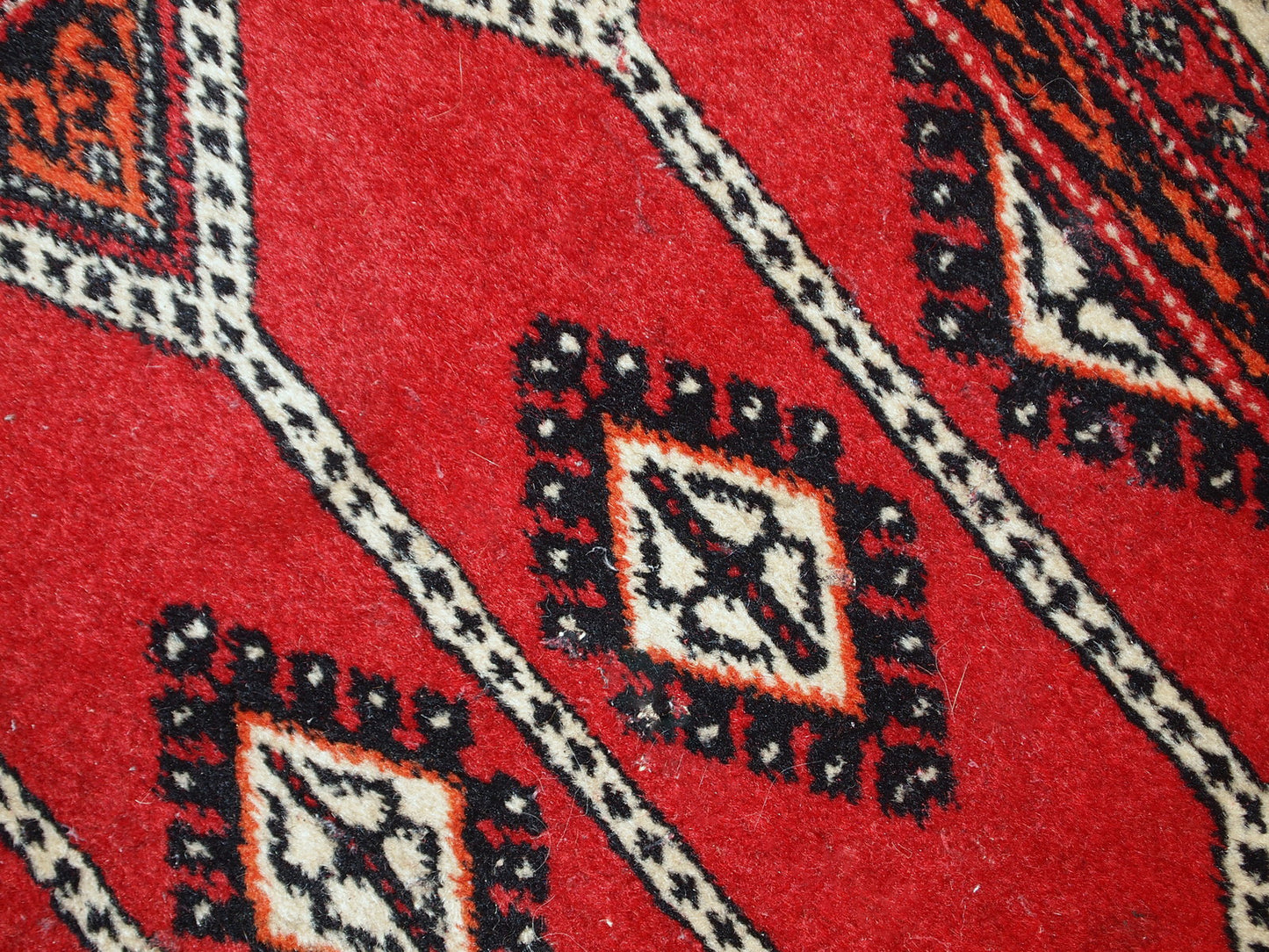 Vintage Lahore rug from Pakistan with traditional patterns and distressed look.

