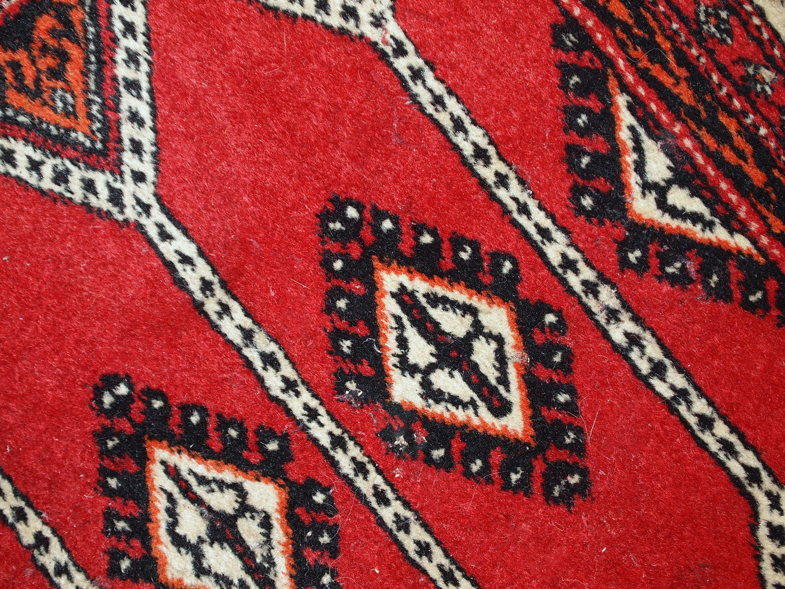 Vintage Lahore rug from Pakistan with traditional patterns and distressed look.

