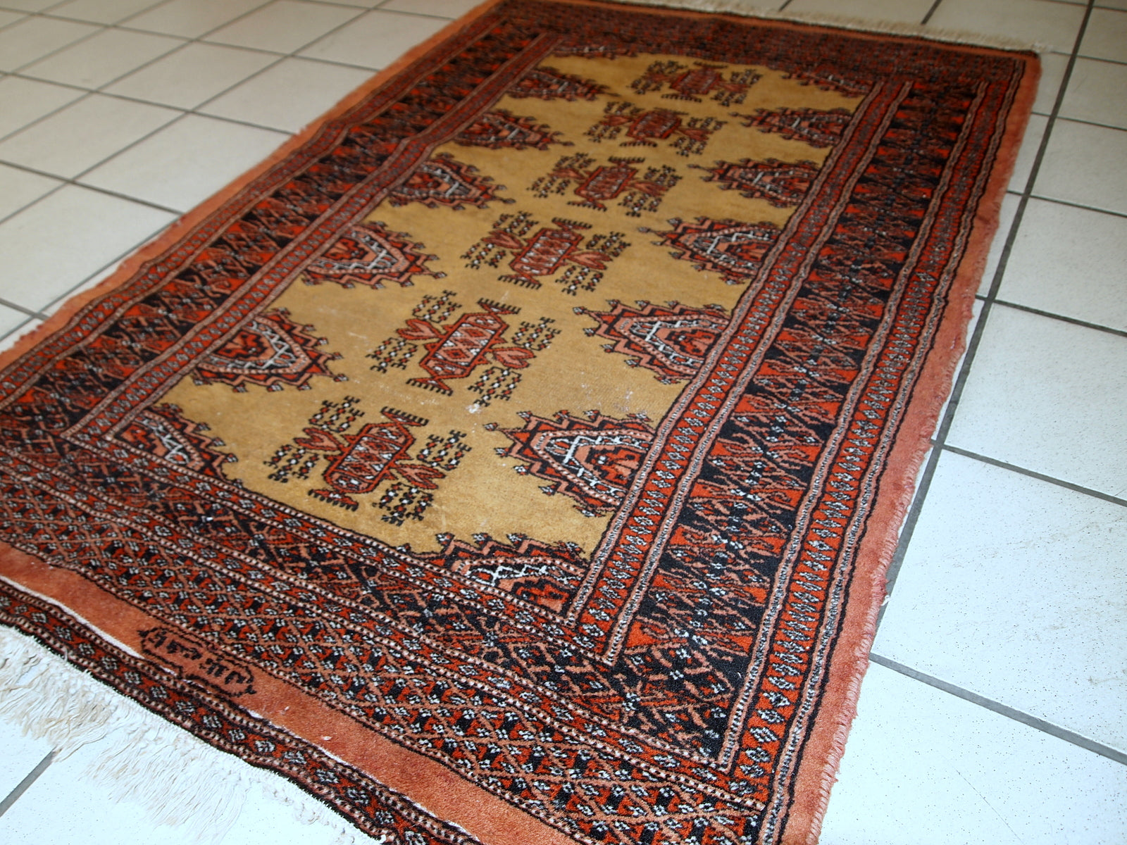 Stunning 1960s vintage Uzbek rug showcasing its age wear and intricate design.

