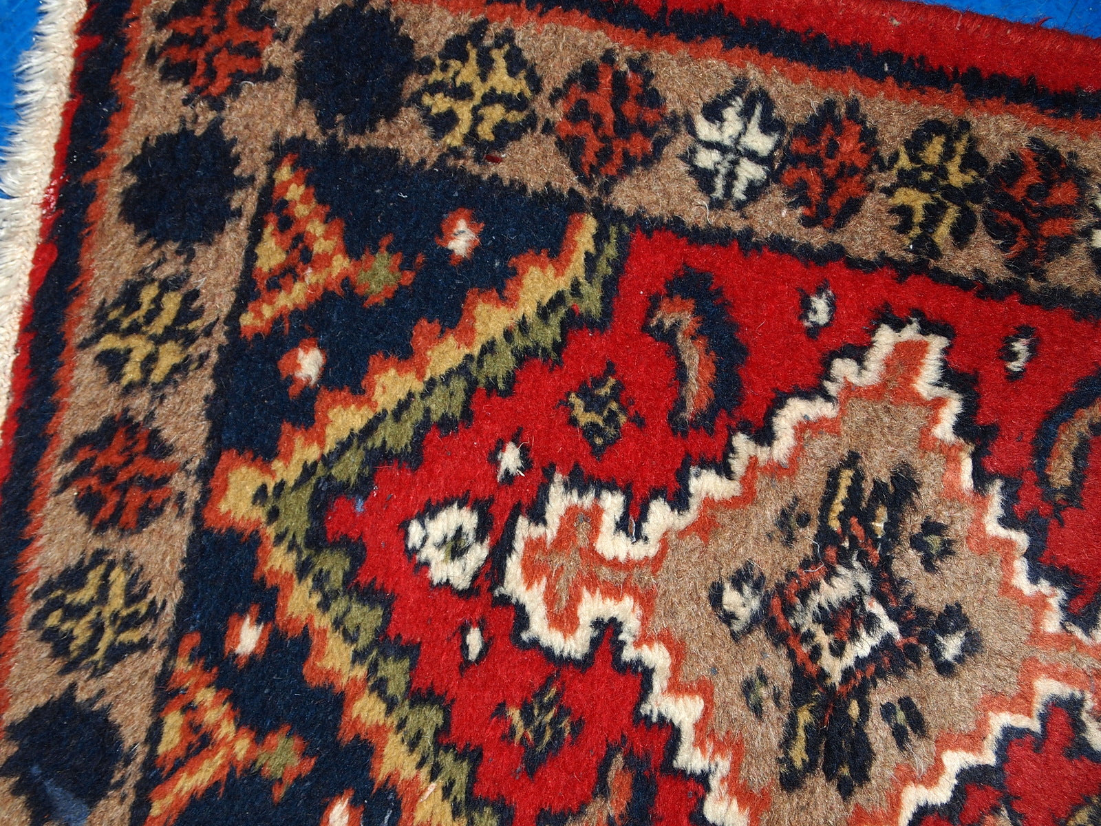 Close-up of the intricate wool weaving in the handmade 1970s Hamadan style rug.

