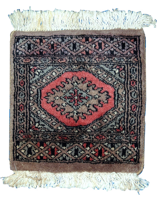 Close-up of red and black wool Bukhara mat

