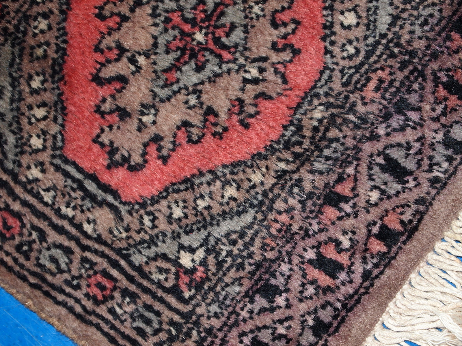 Handmade wool texture from 1960s Bukhara mat

