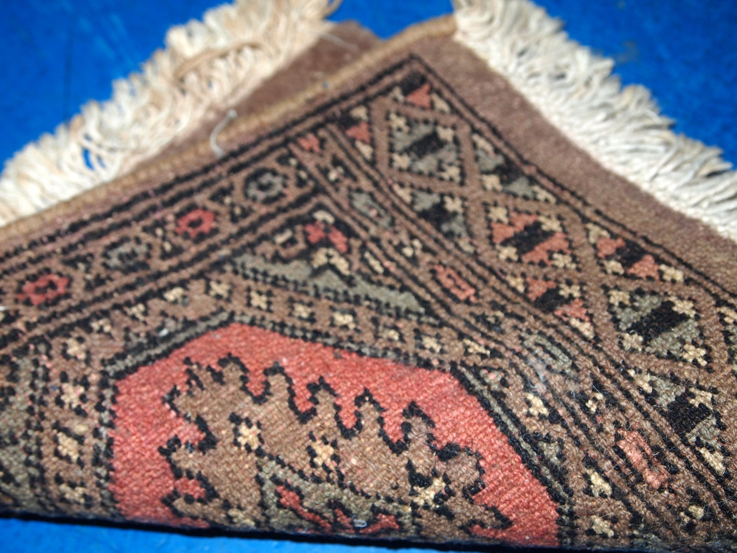 Vintage Uzbek wool rug showing corner detail

