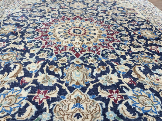 Central medallion design of the Nain rug with intricate floral motifs
