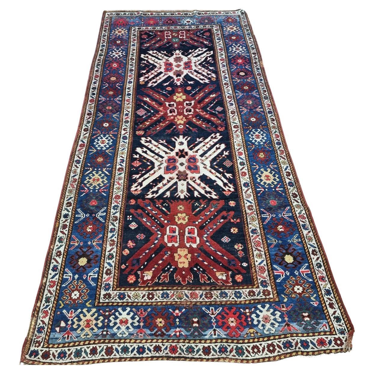 Full view of the Handmade Antique Caucasian Kazak Rug with geometric patterns
