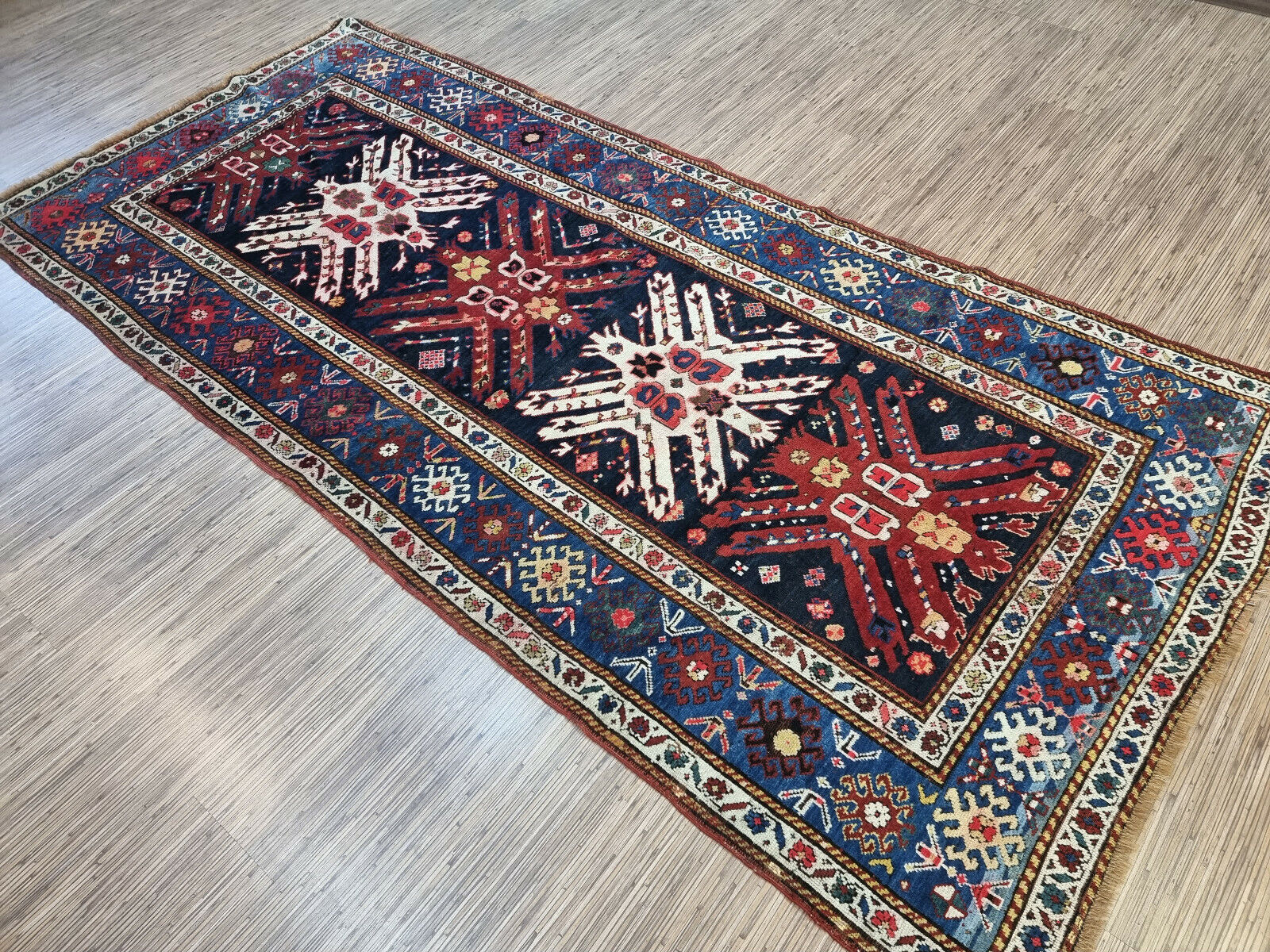 Symmetrical geometric shapes in the center of the Kazak rug
