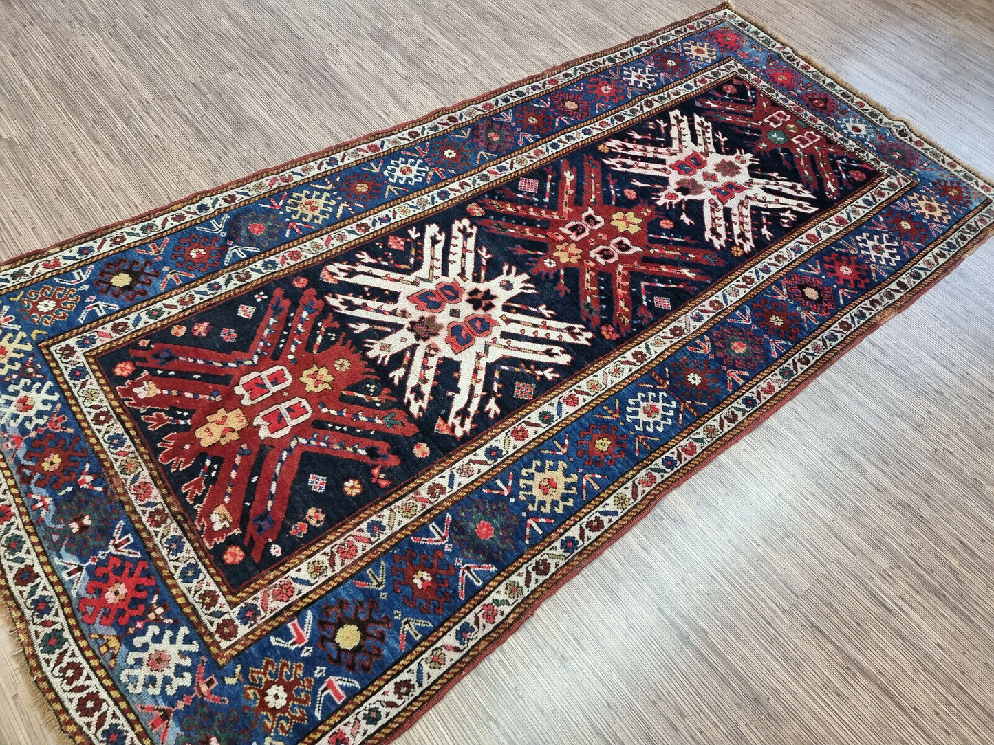 Close-up showing the intricate details of the geometric patterns in the rug
