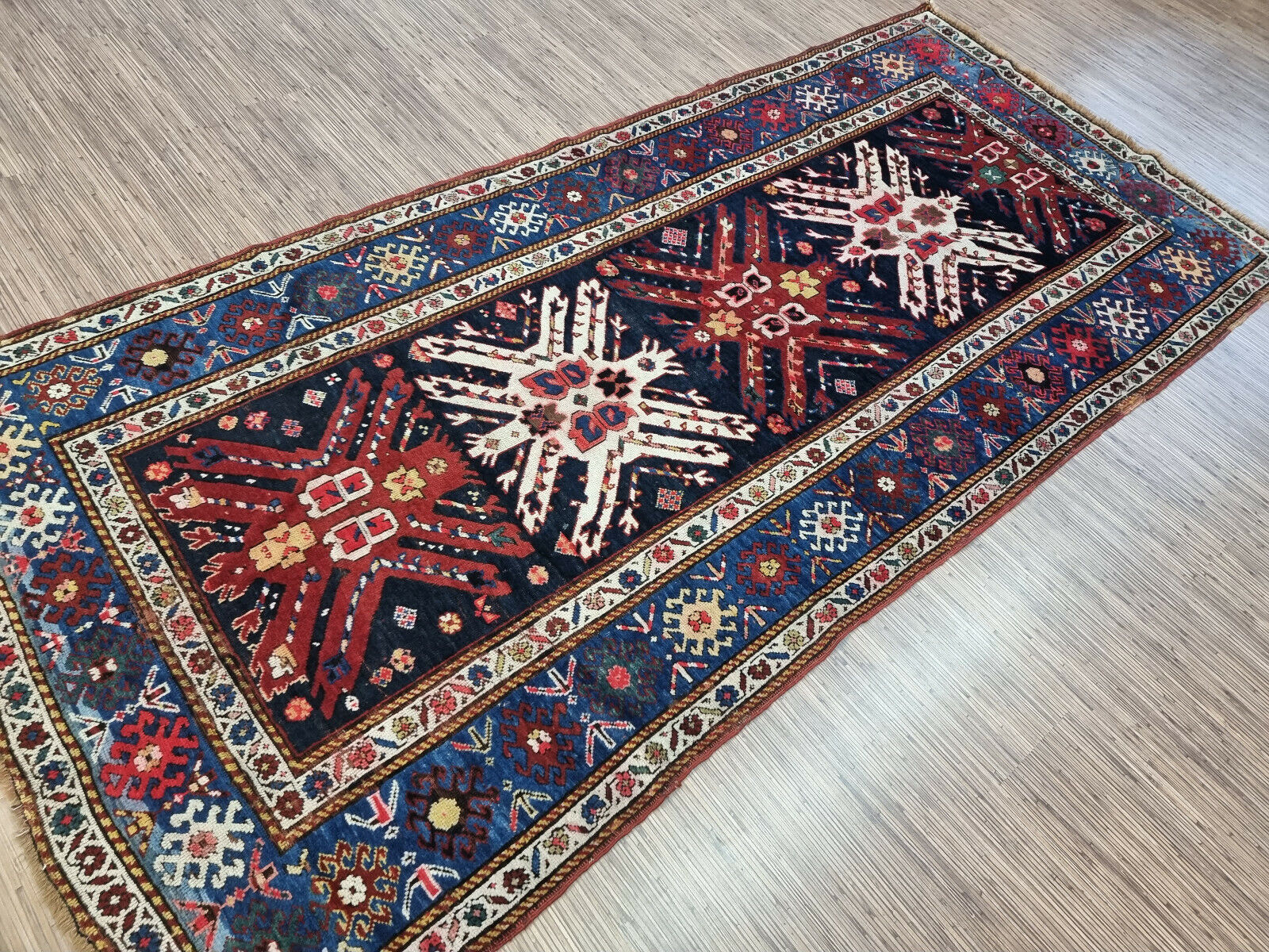 Close-up showing the intricate details of the geometric patterns in the rug
