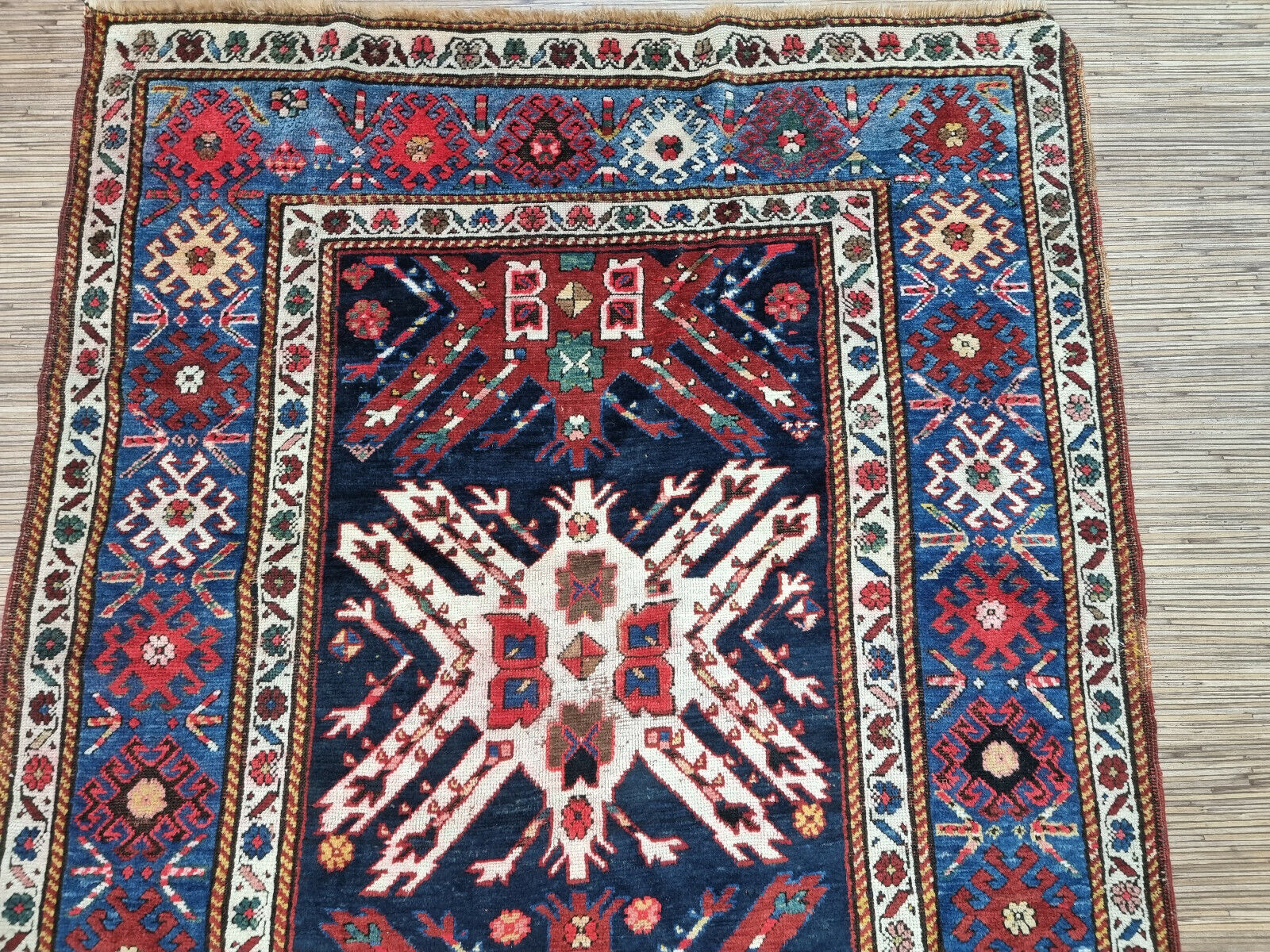 Close-up view of the handmade wool weave of the Kazak rug
