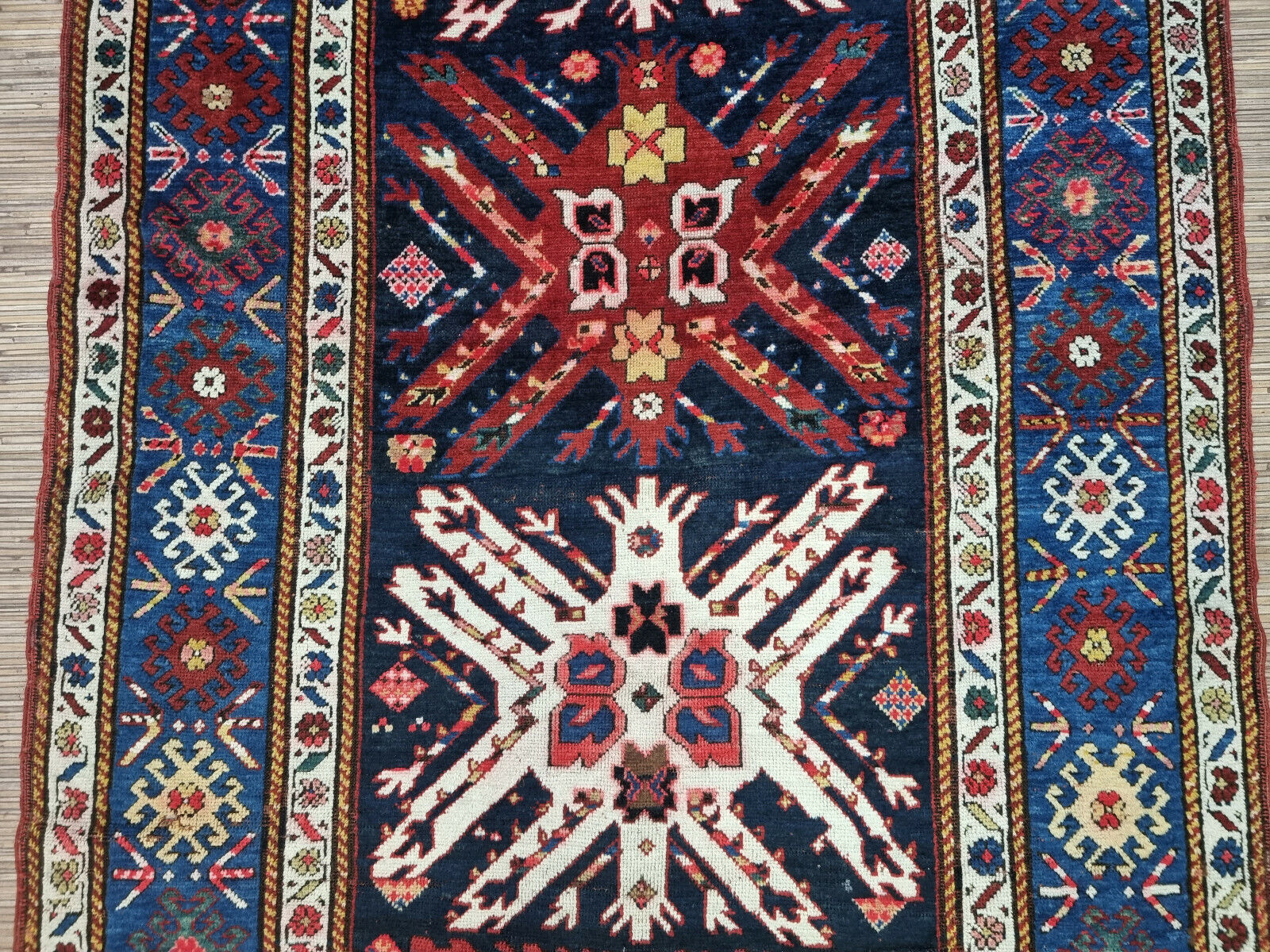 Full-length view of the Antique Caucasian Kazak Rug on hardwood floor
