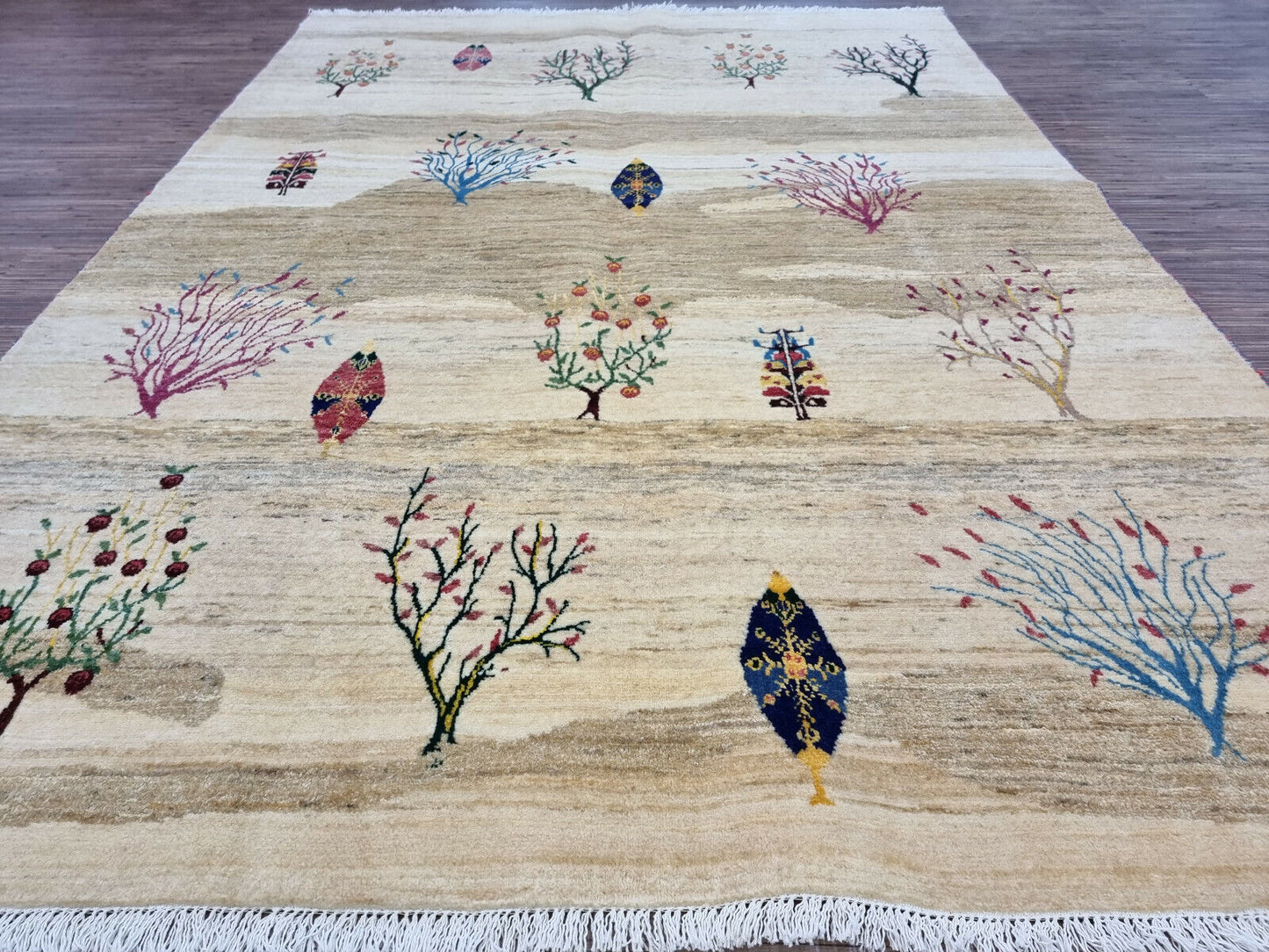 Artistic tree details in blue, red, green, and yellow on the rug

