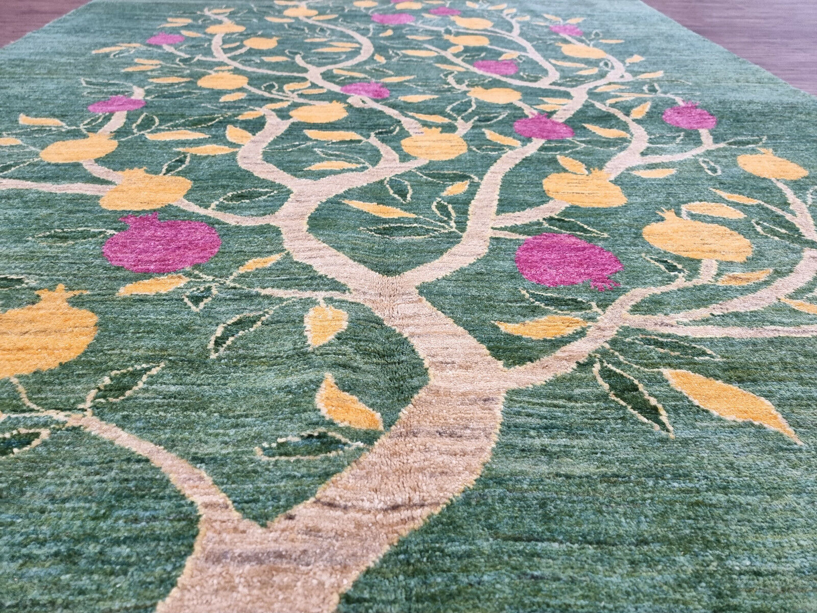 Vivid yellow and pink details against the beige branches of the tree design
