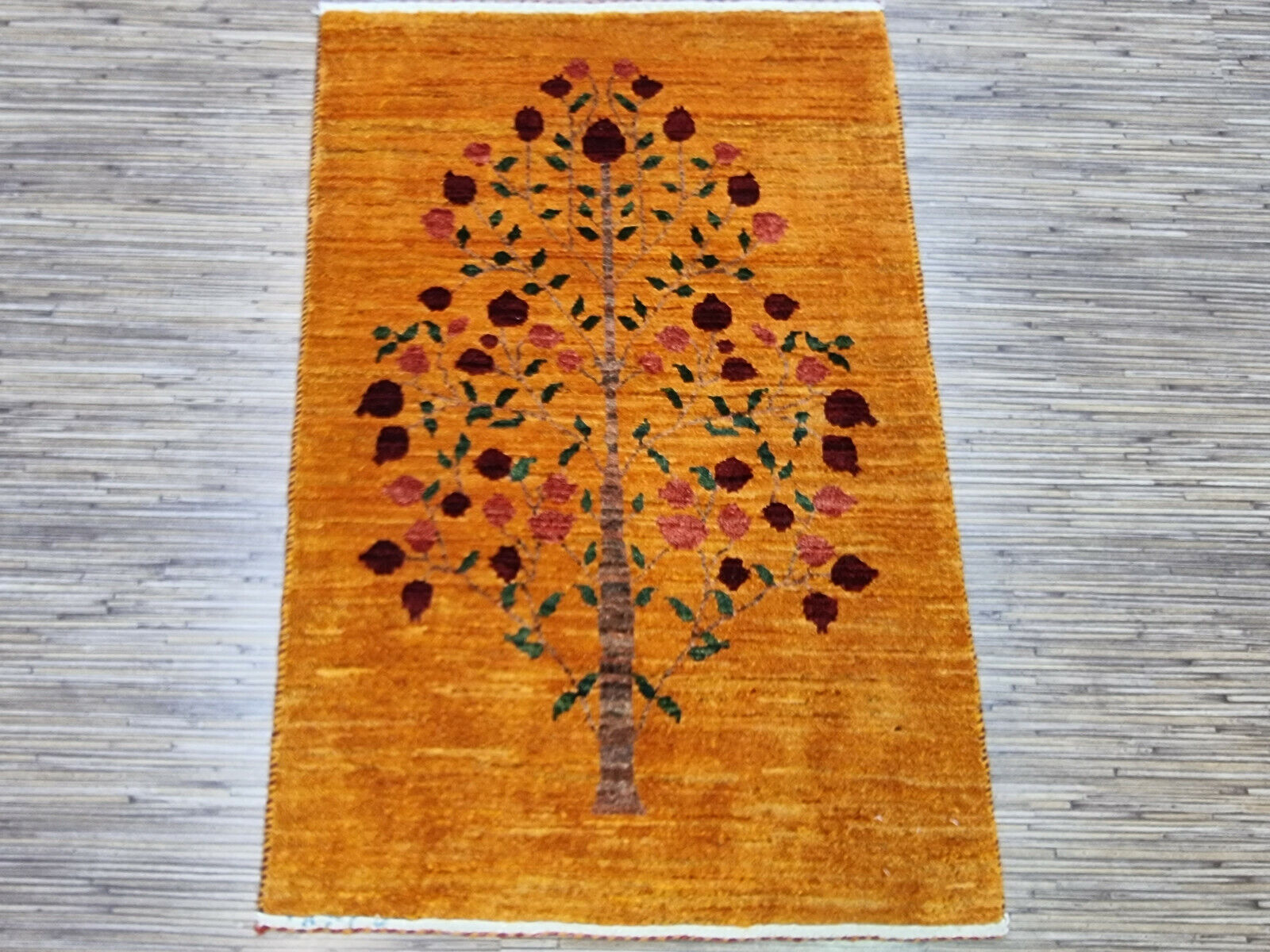 Close-up of beige Persian Gabbeh rug design and texture
