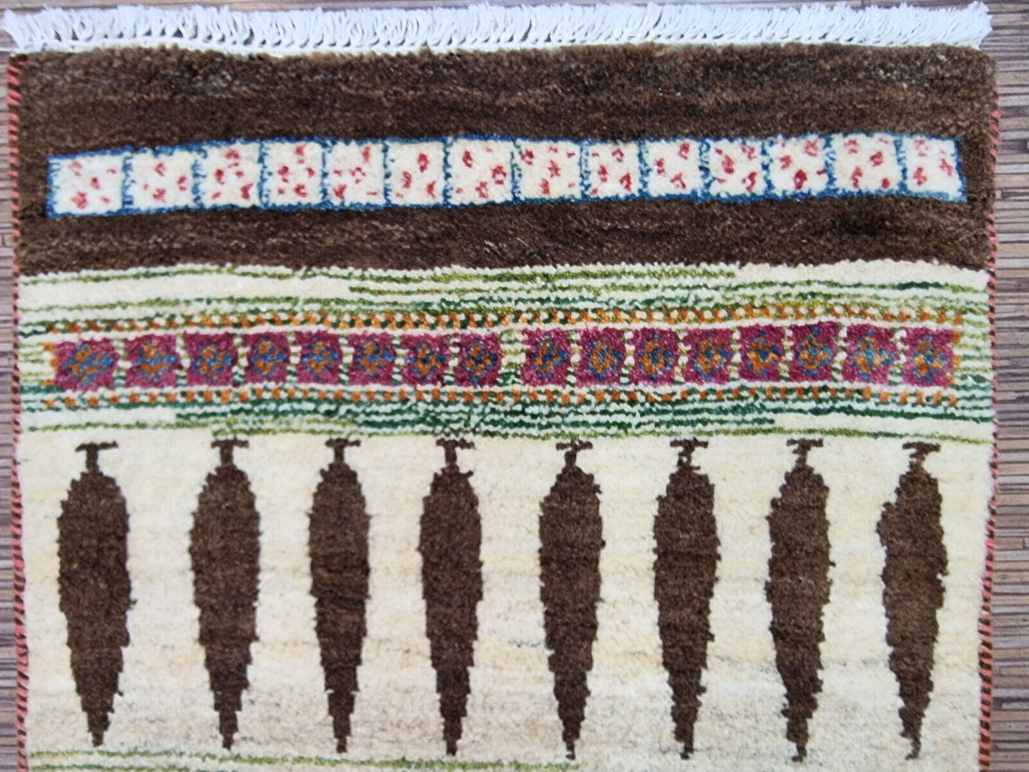 Rectangular Persian Gabbeh rug displayed on hardwood flooring
