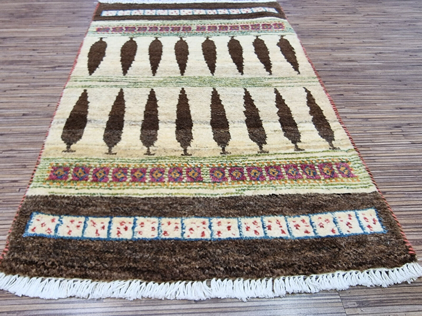 Border detail of Persian Gabbeh rug with beige tones
