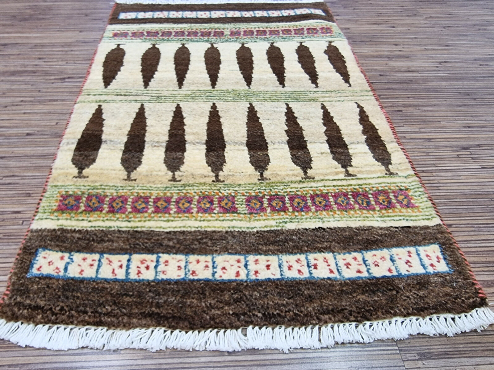 Border detail of Persian Gabbeh rug with beige tones
