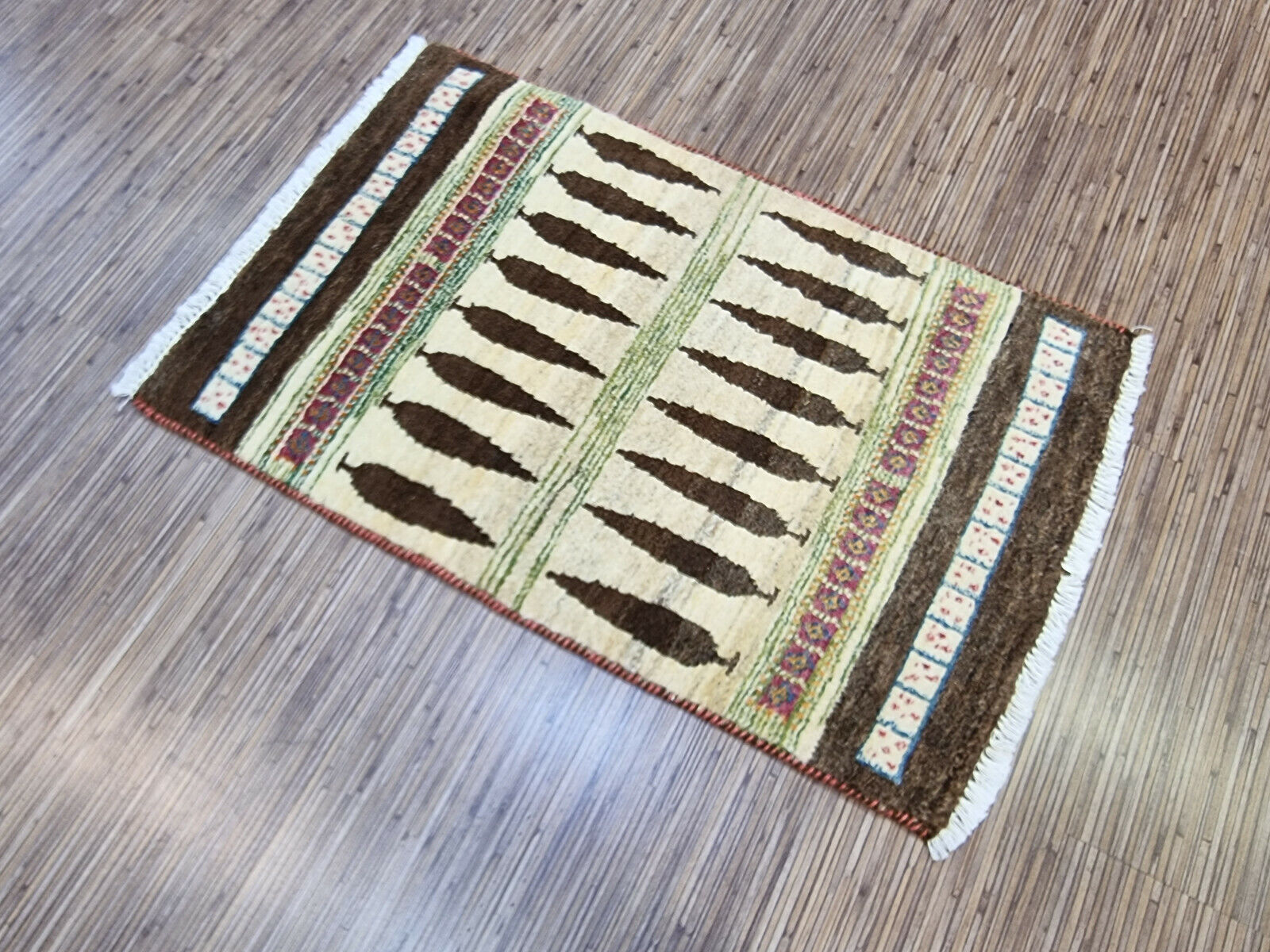 Persian Gabbeh rug rolled up, showcasing original tags

