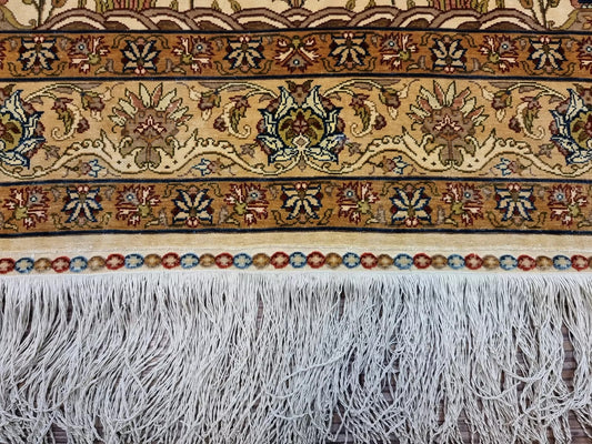 Close-up of the hand-knotted Hereke prayer rug with a medallion centerpiece
