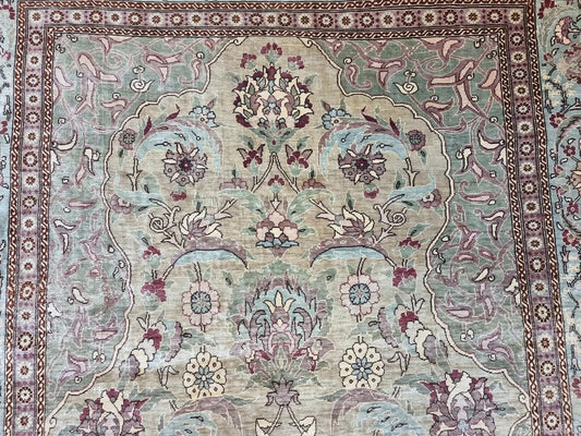 Vintage Turkish Hereke silk prayer rug with intricate floral patterns and a turquoise border
