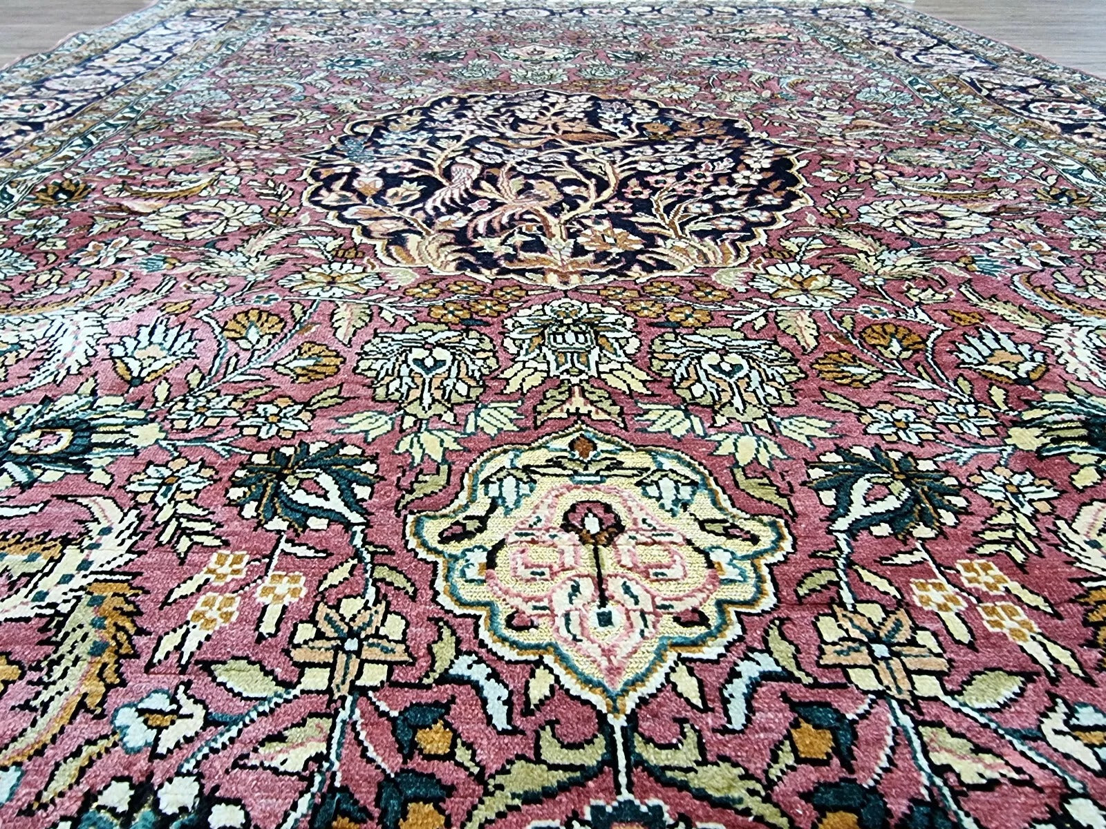 Handwoven Chinese silk rug with classic Persian-inspired design.
