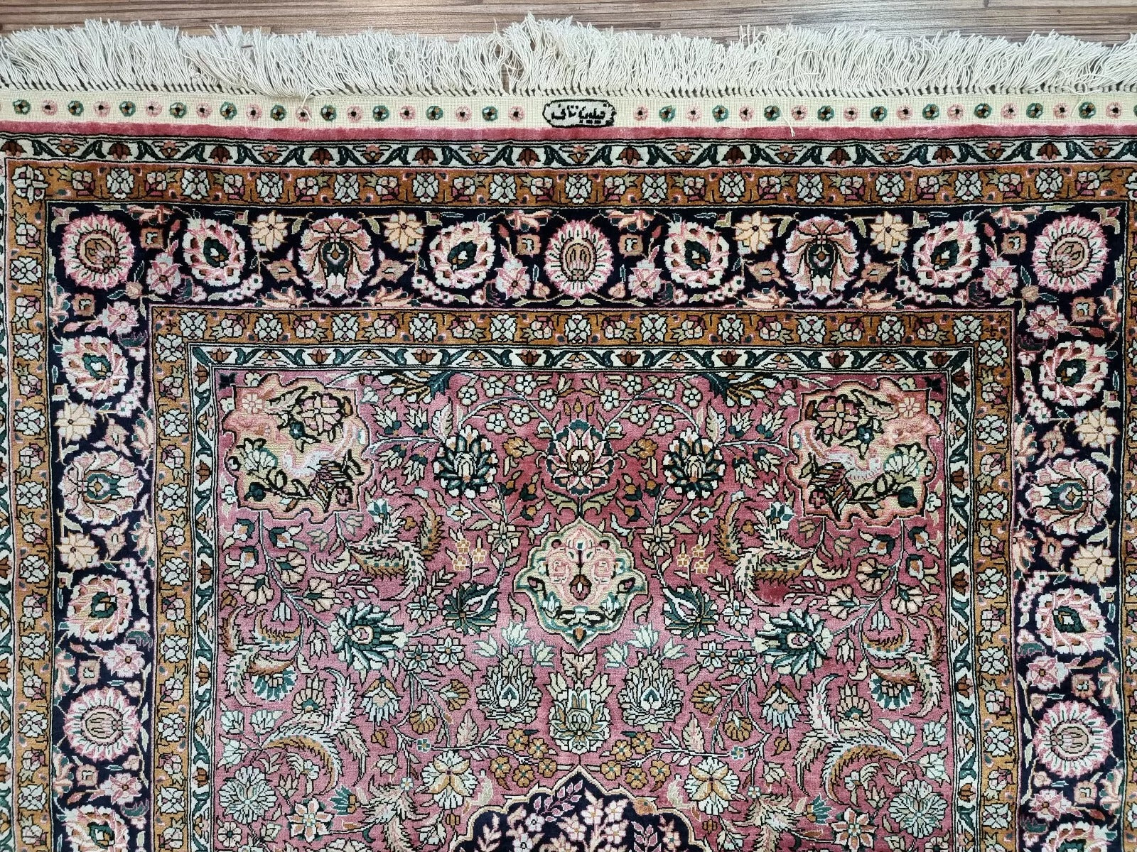 Rectangular Chinese Qum silk rug with vibrant Oriental motifs.
