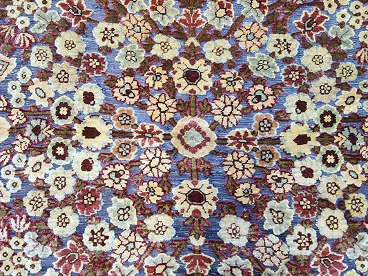Close-up of hand-knotted silk details on a vintage Hereke rug.
