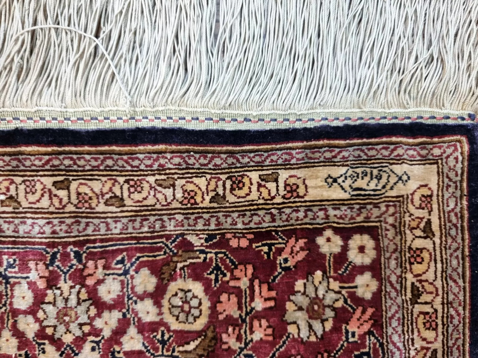 Turkish Hereke rug displayed as a luxurious wall hanging.
