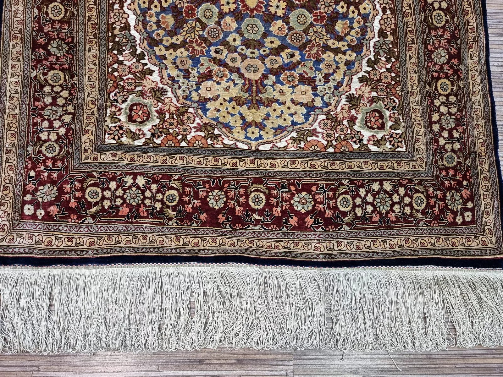 Artisan-signed Turkish Hereke silk rug, showcasing fine craftsmanship.
