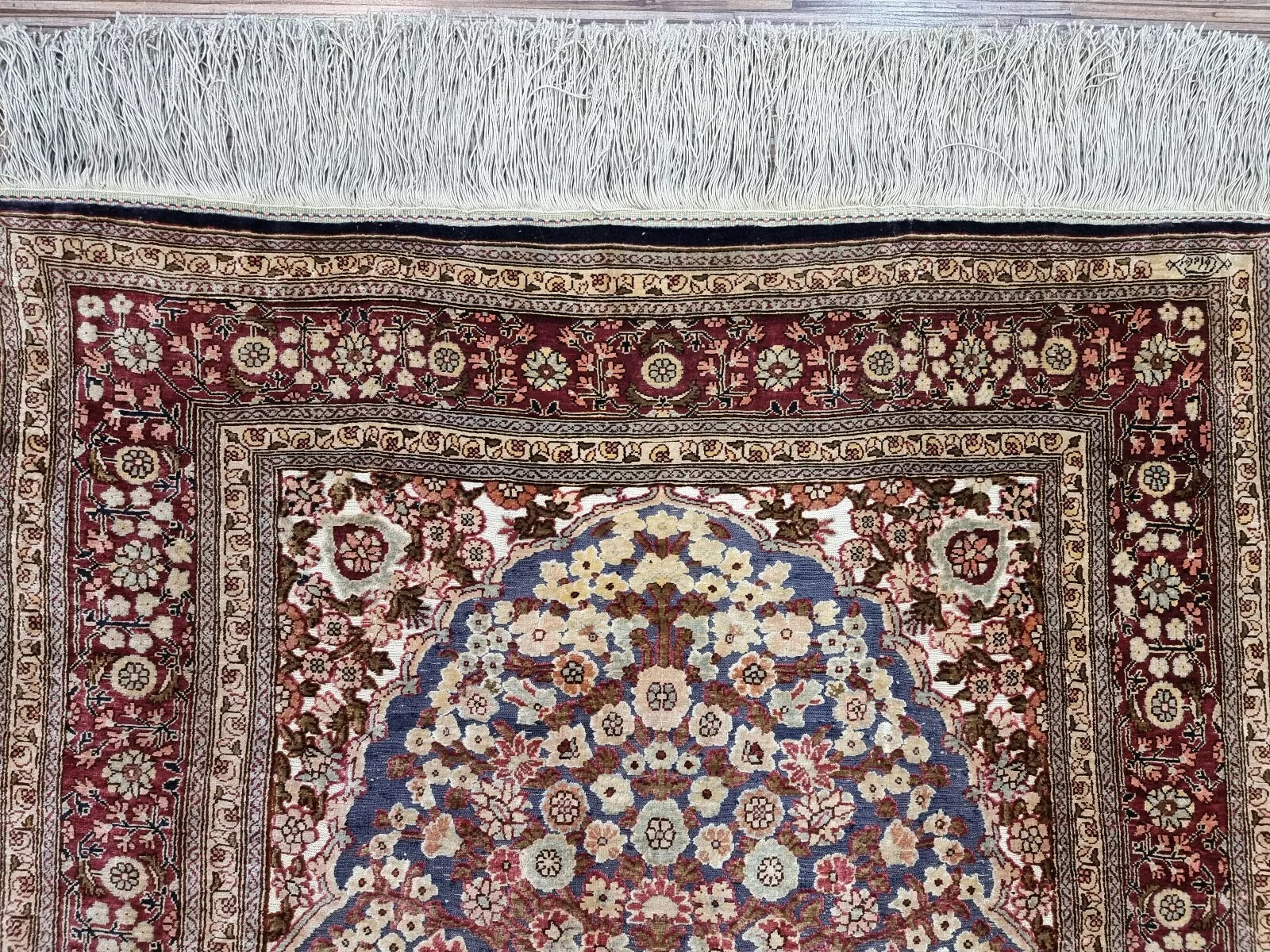 Vintage hand-knotted silk rug with radiant sheen and elegant design.
