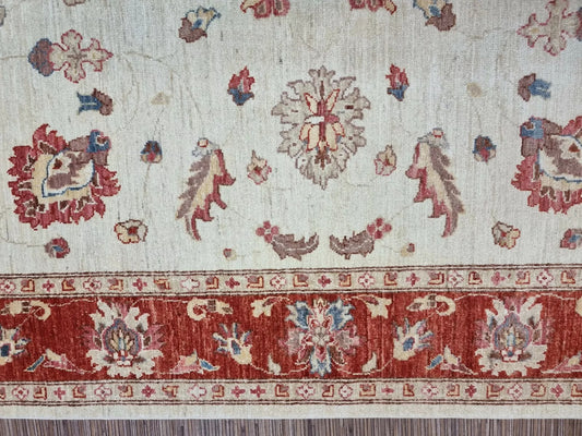 Handmade wool rug in soft cream and rust tones

