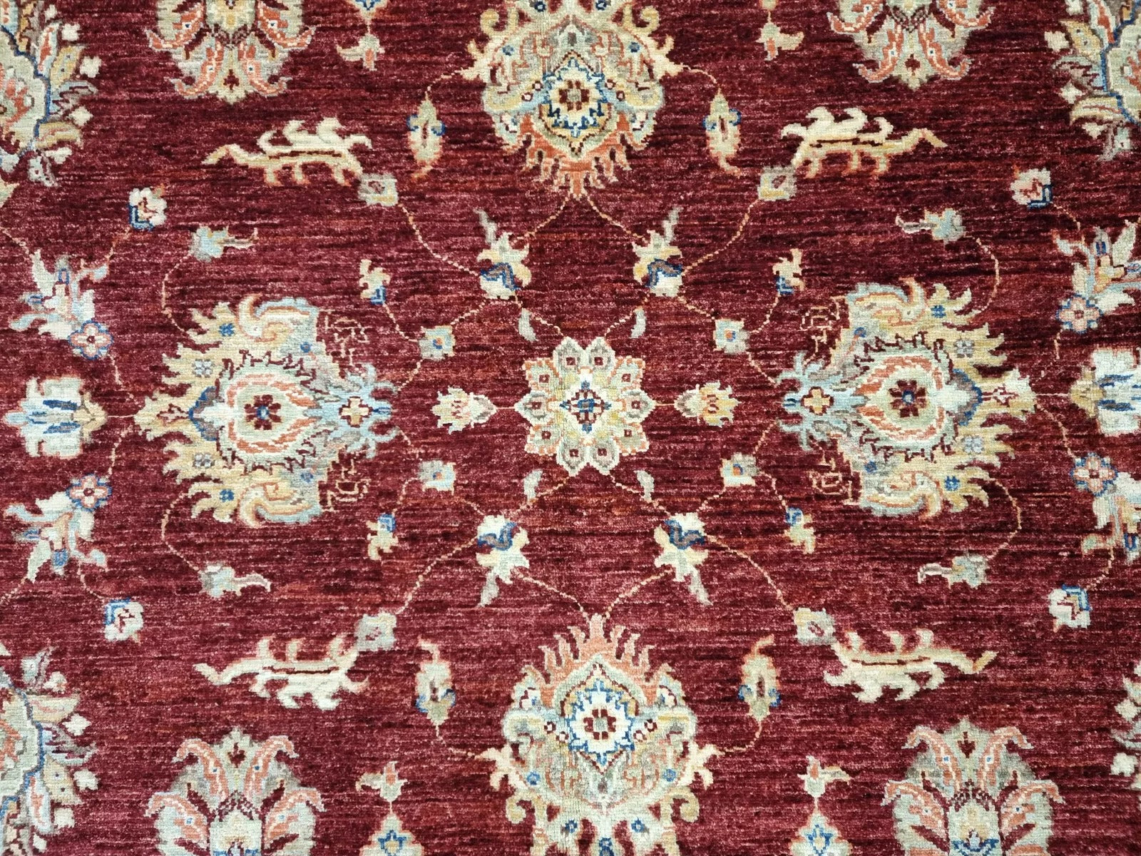 Room-sized Afghan rug with warm earth colors

