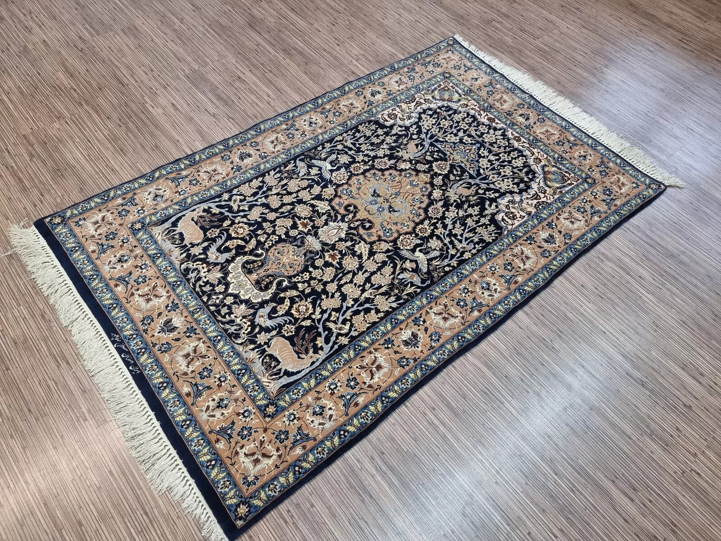 View of the rug's spandrels filled with detailed floral and vine patterns.

