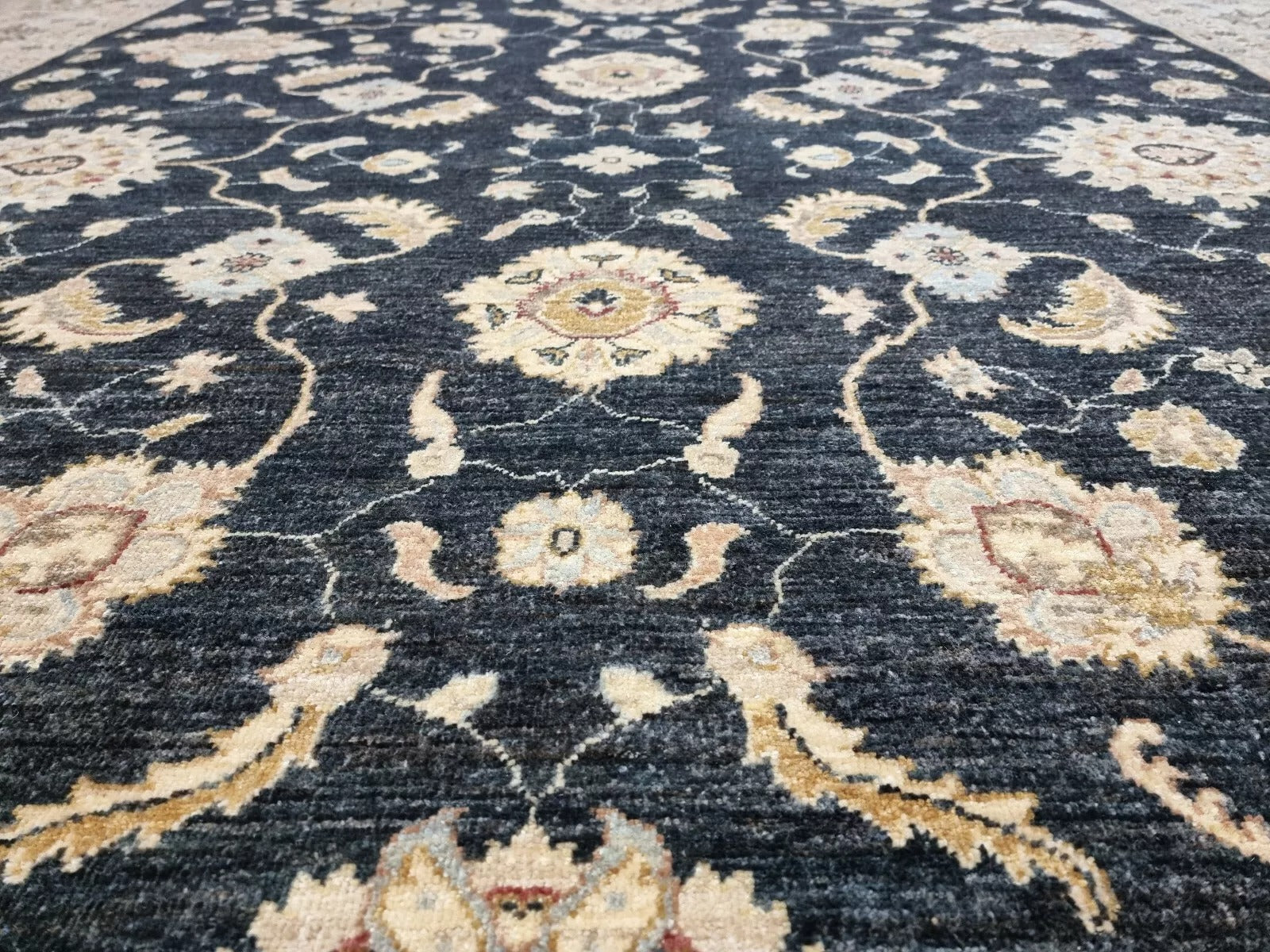 Detail of the rug's corner, displaying the seamless pattern flow.

