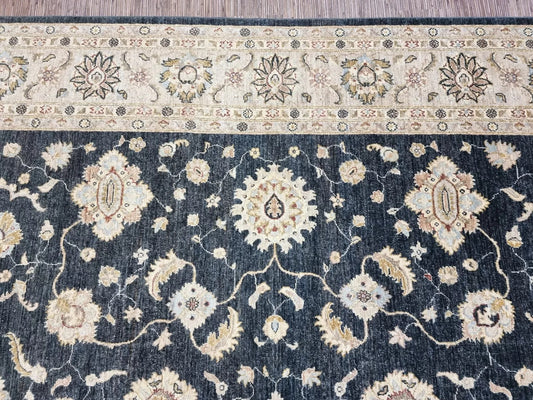 Close-up detail of an elegant floral medallion in deep black wool.

