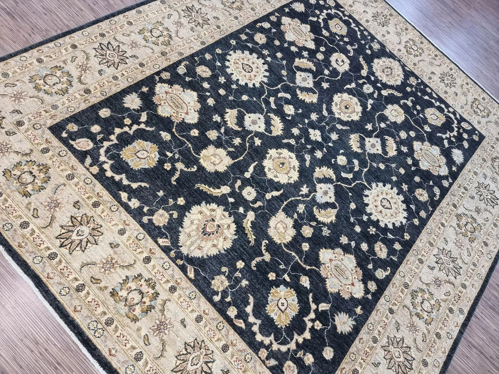A section of the rug showcasing the rhythmic repetition of the floral motifs.

