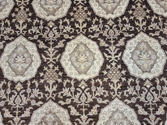 Close-up detail of a large floral medallion in rich, dark brown wool.

