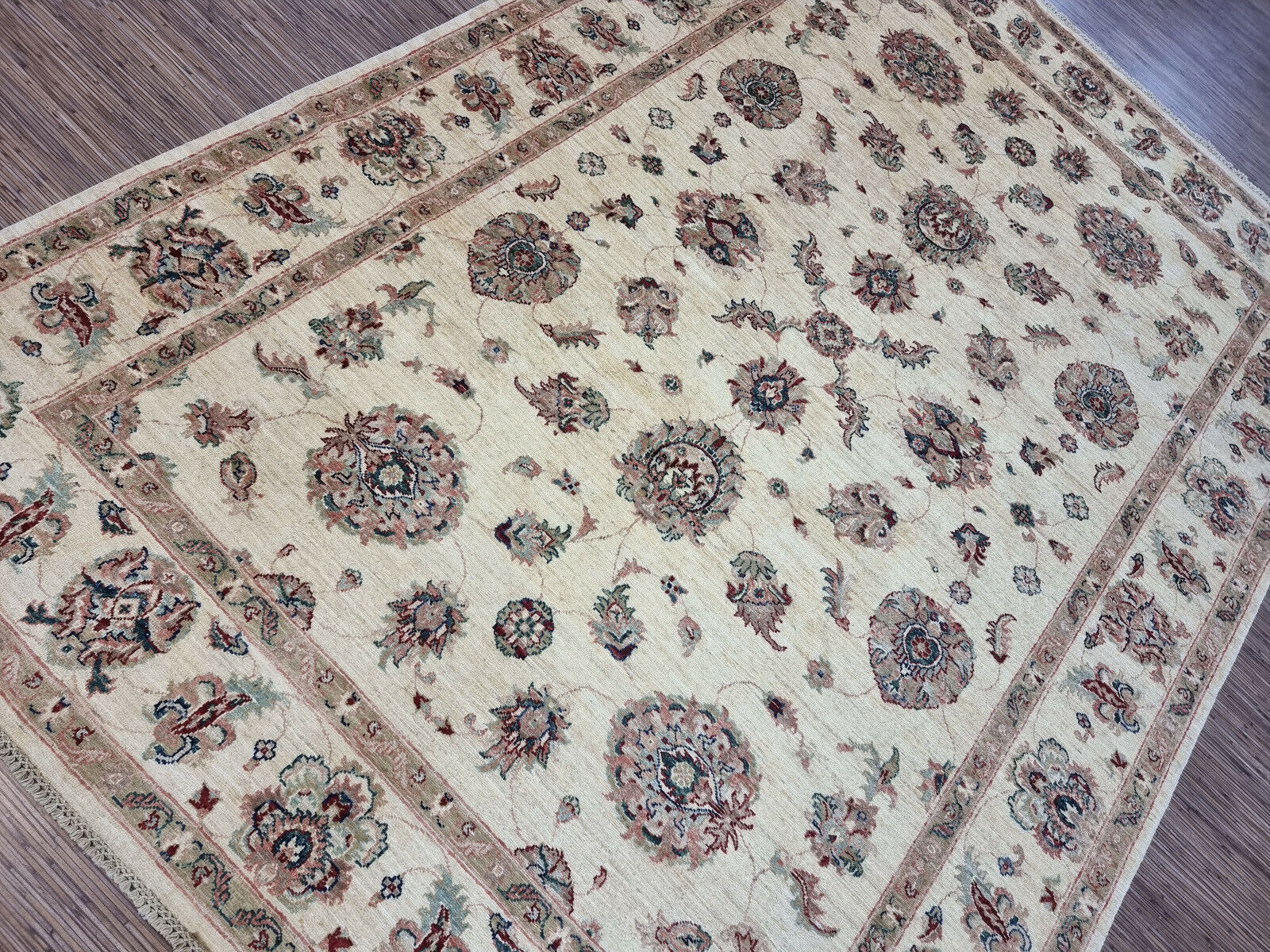 Shot focusing on the intricate vine and leaf motifs in subtle beige tones.

