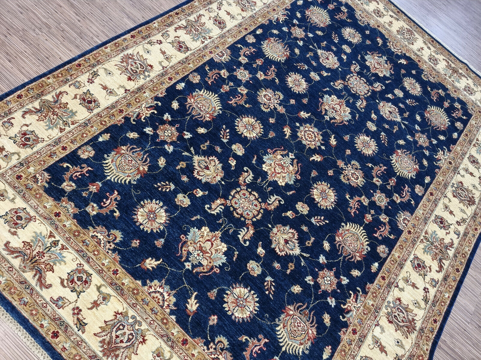 Shot focusing on the intricate vine and leaf motifs in shades of cobalt and sapphire.

