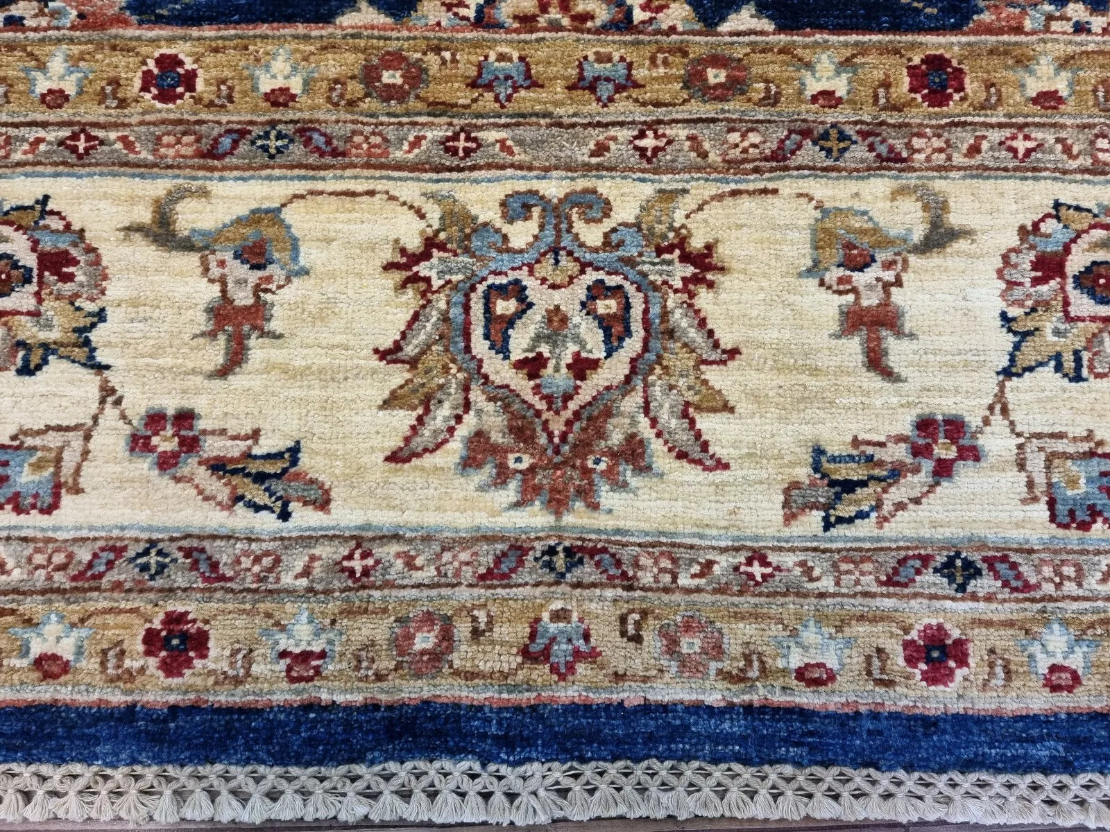 Detail of the darker blue background and the wool's textured, lustrous surface.

