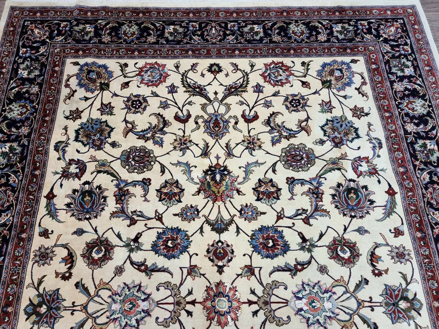 Texture shot showing the contrast between the navy blue wool and creamy ivory motifs.

