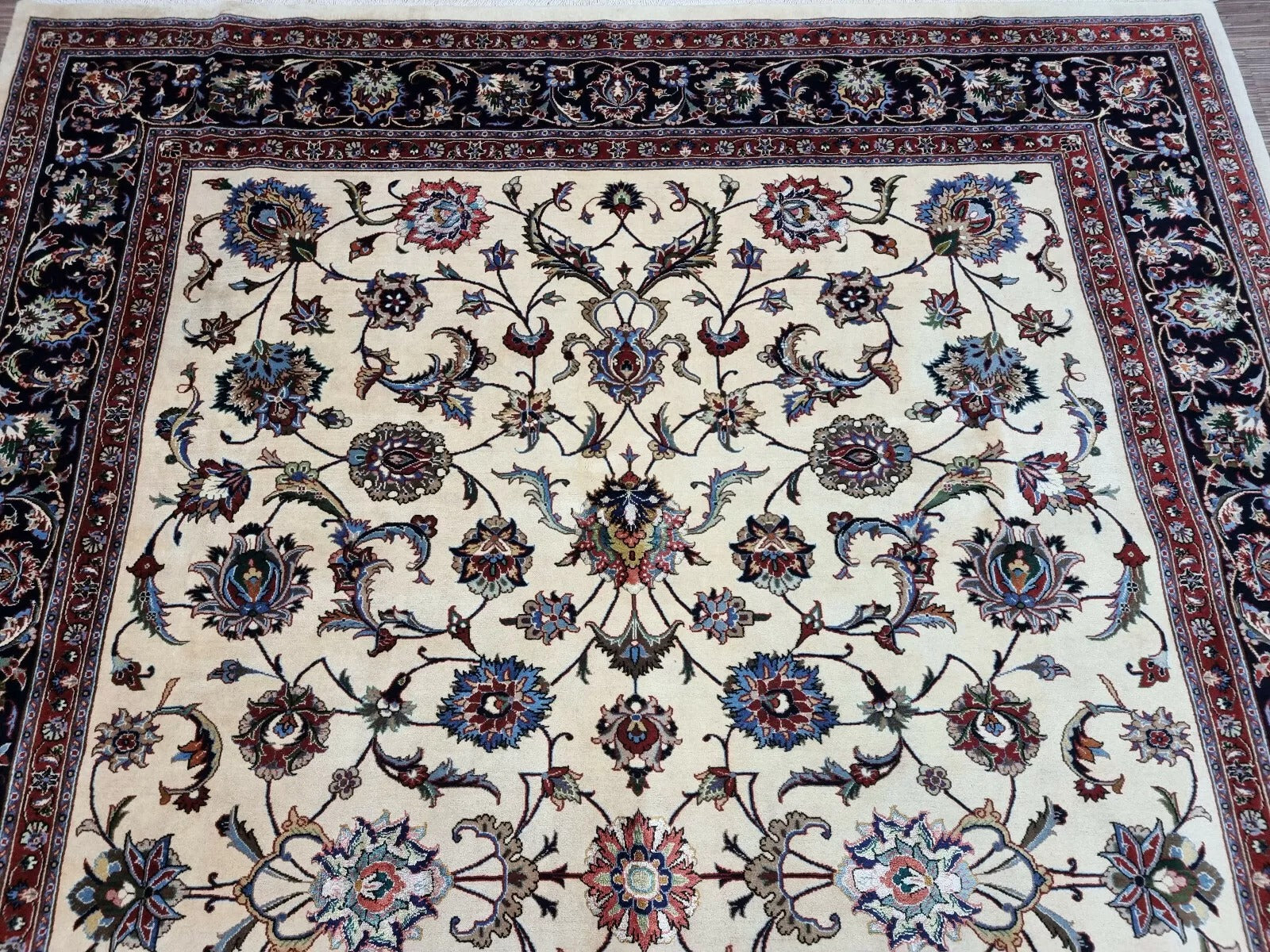 Texture shot showing the contrast between the navy blue wool and creamy ivory motifs.

