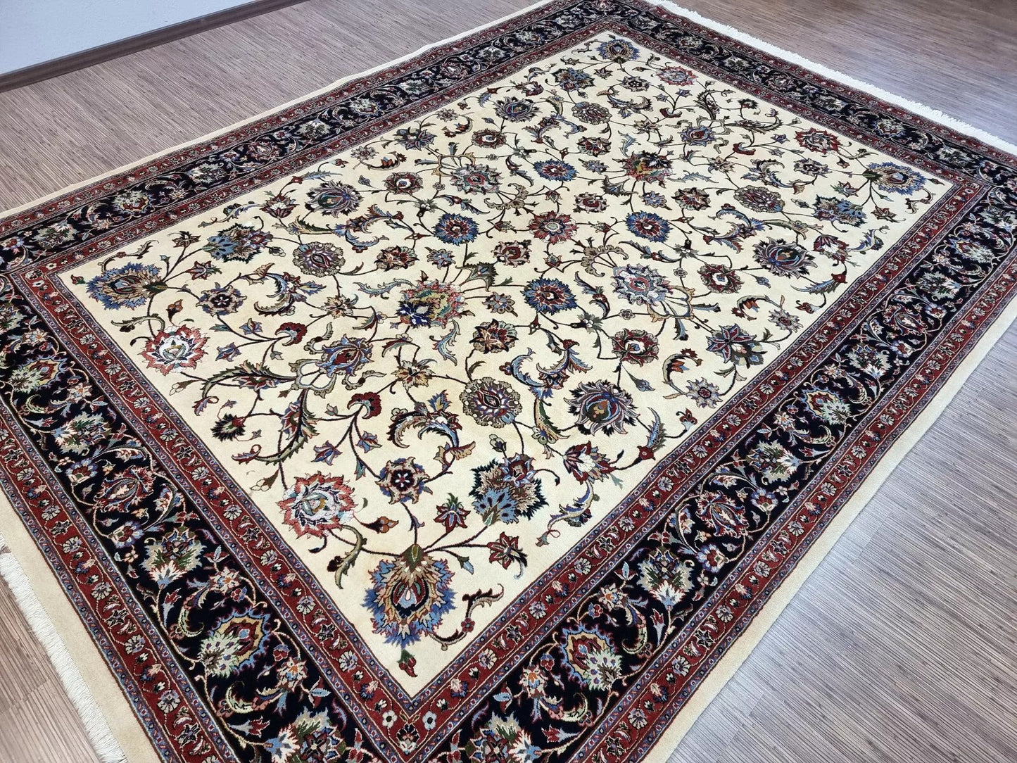 View of the rug's elaborate floral border framing the central field.

