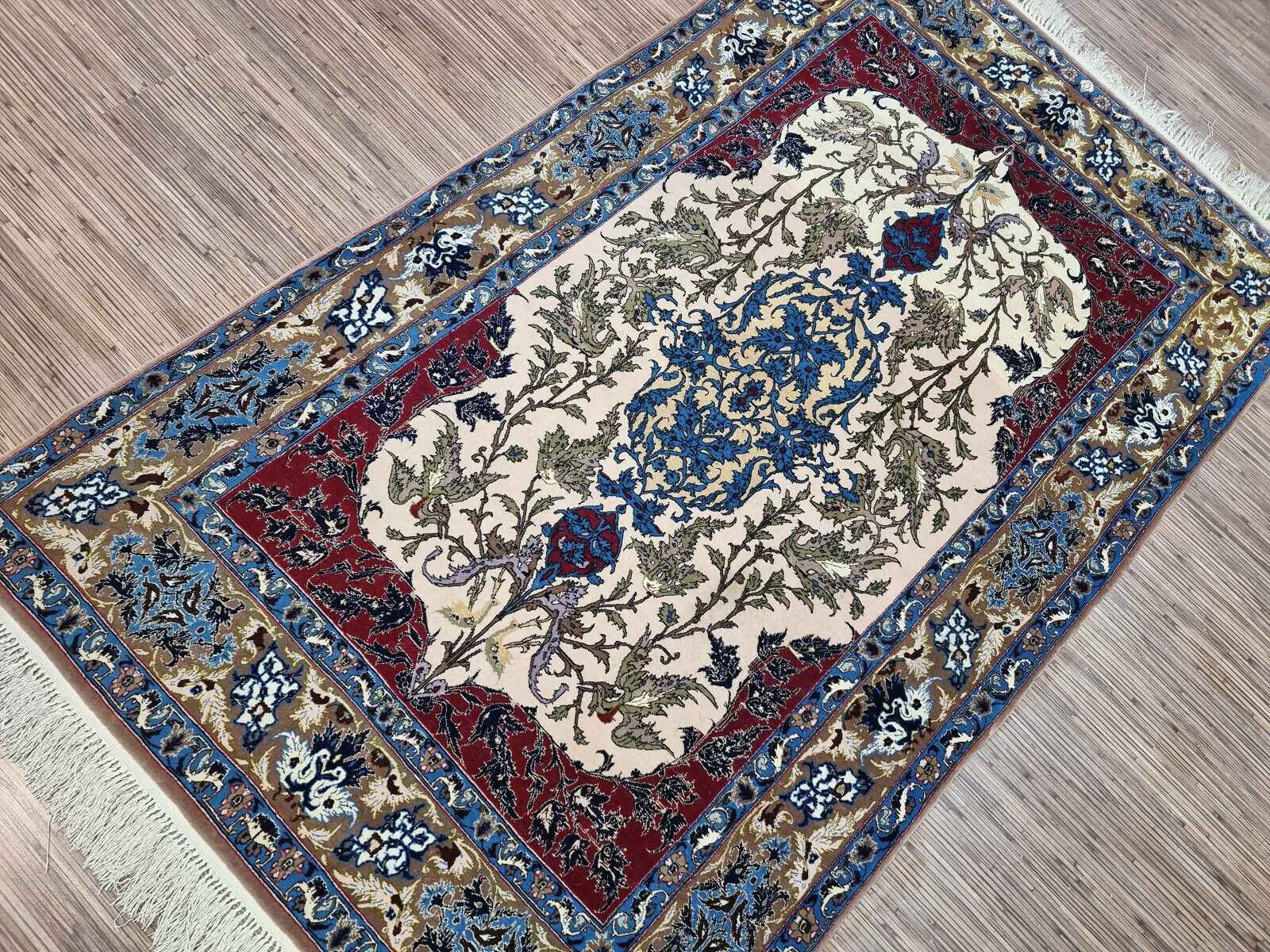 Detail of the rich crimson background and its luxurious silk texture.

