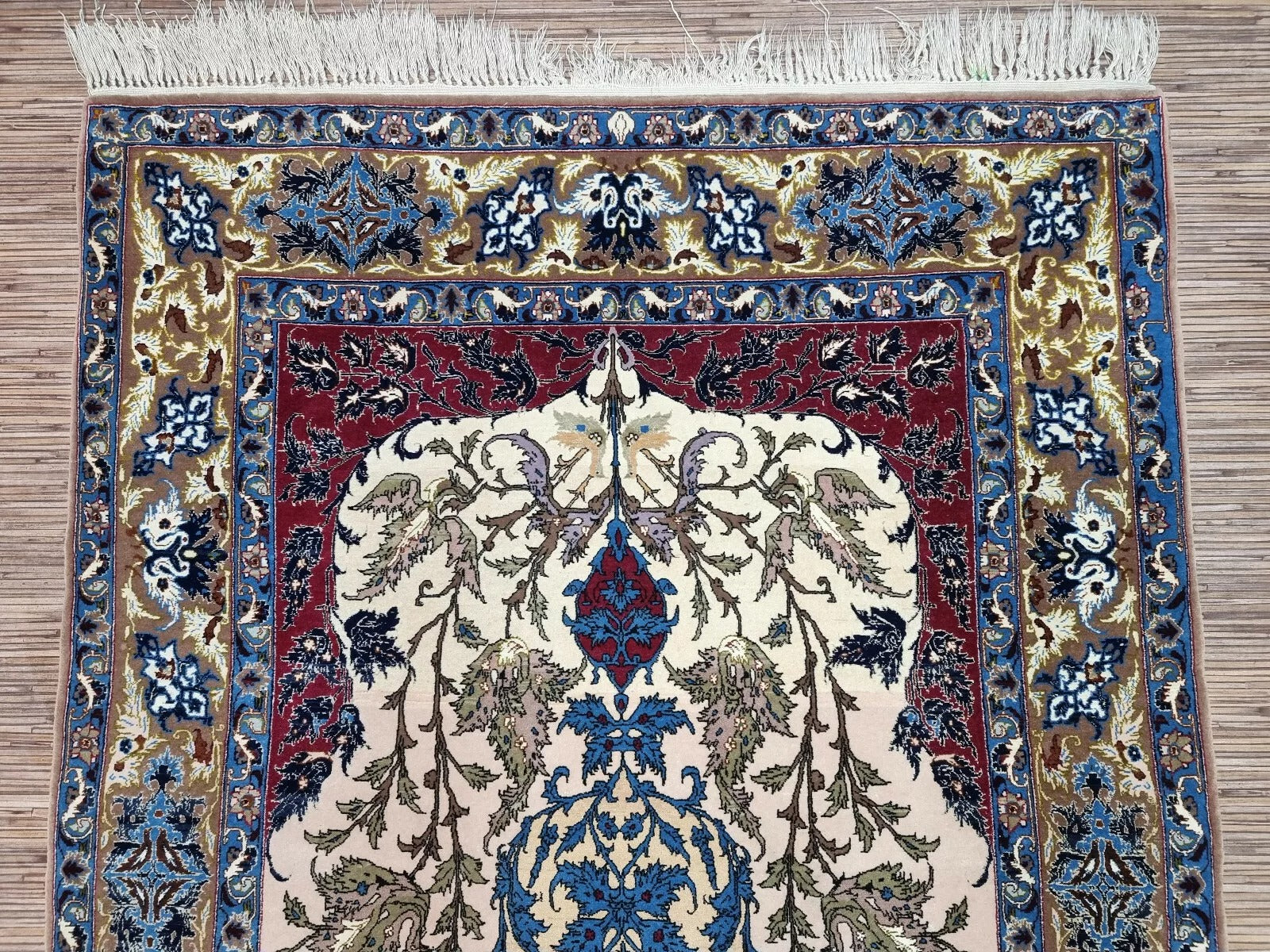 View of the rug's elaborate floral border framing the central field.

