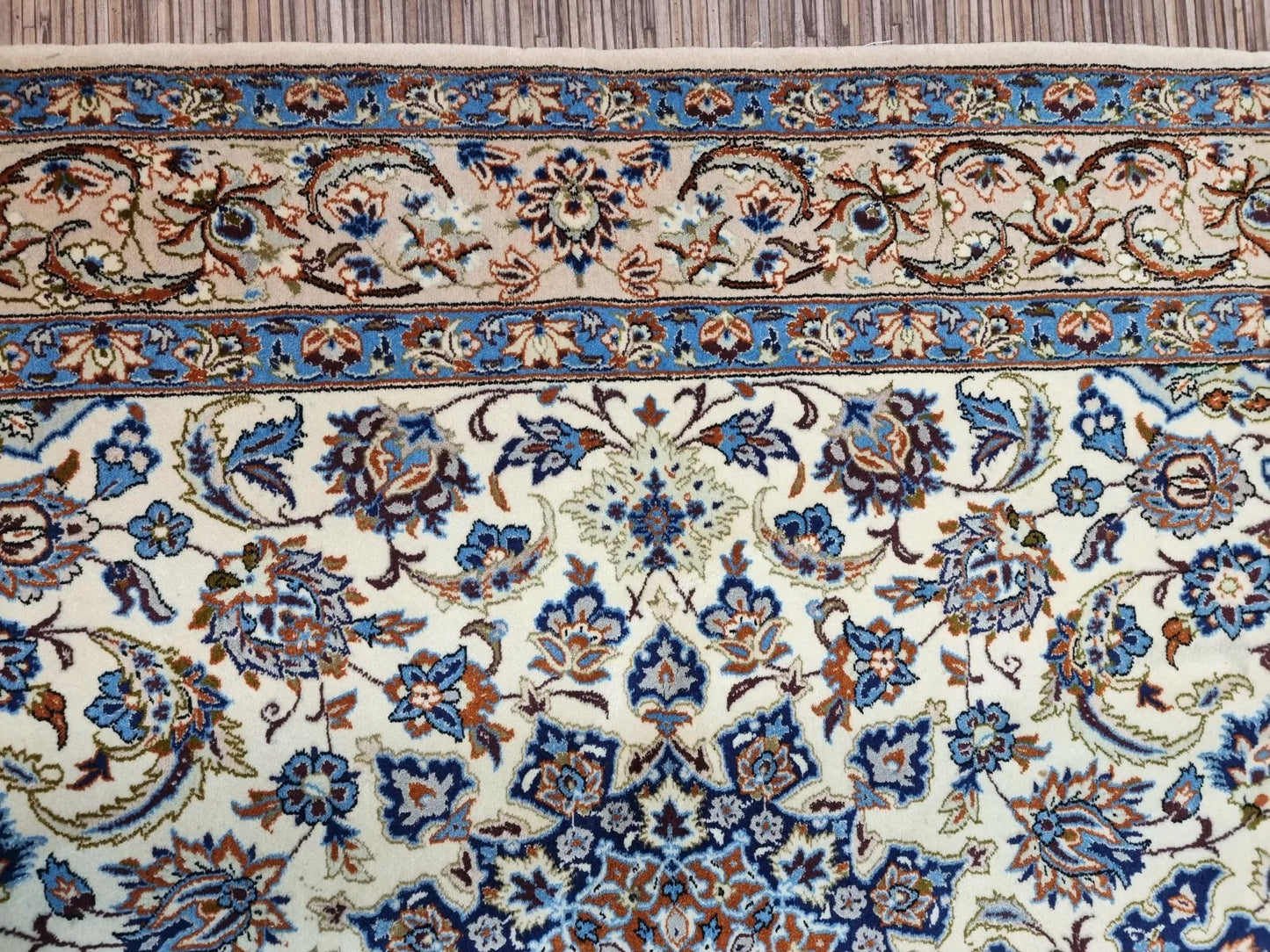 Handmade 1970s Persian Isfahan rug with a 100% hand-knotted construction, guaranteed not machine-made, featuring traditional floral sprays and vine scrolls.

