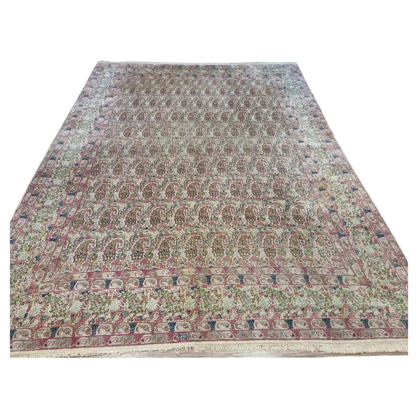 Full view of a handmade vintage Persian Kerman rug from the 1930s, featuring soft beige tones, classic intricate patterns, and a large room-size format measuring 9.8 x 13 feet.

